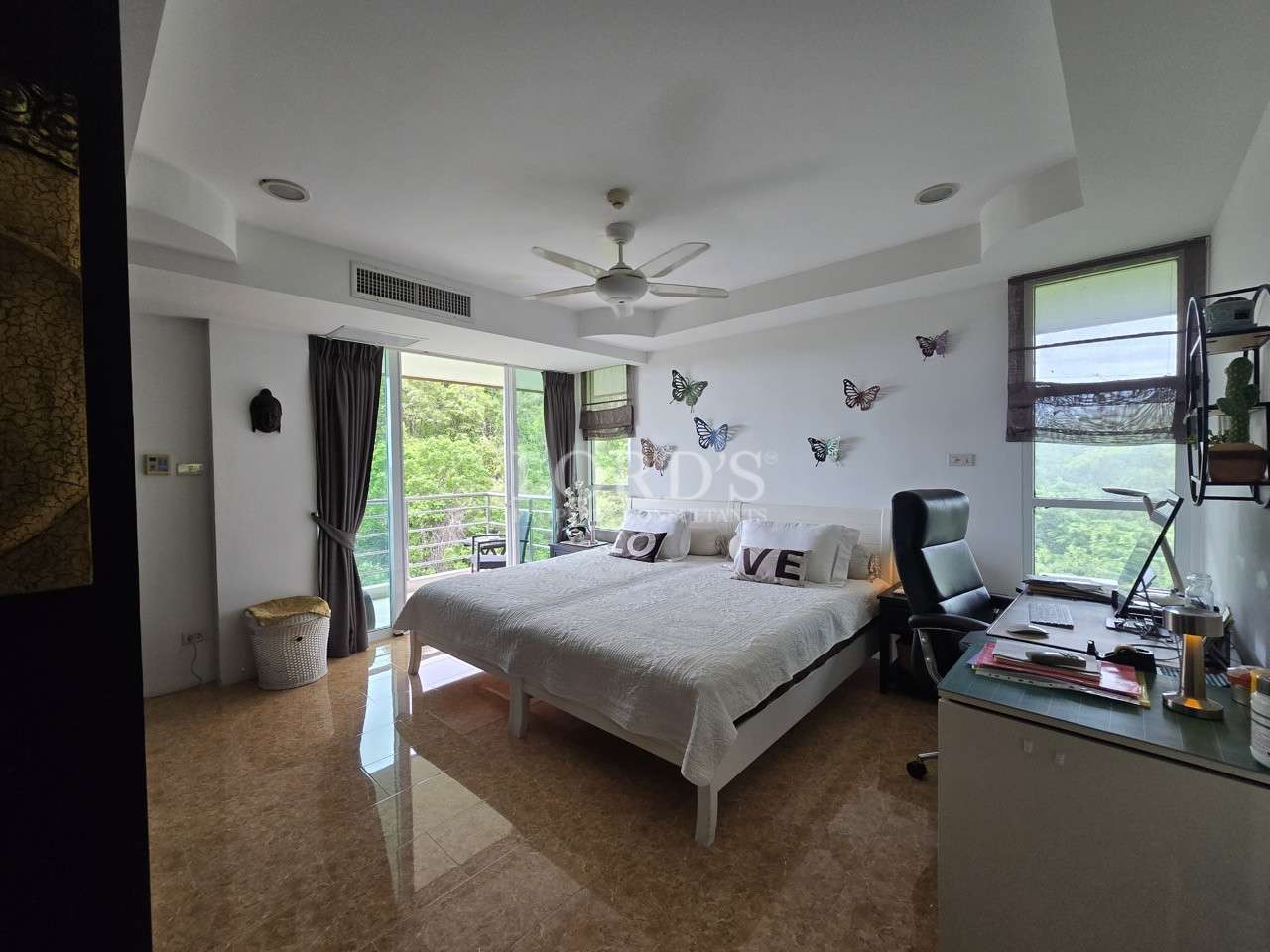 Modern bedroom with balcony access and workspace.