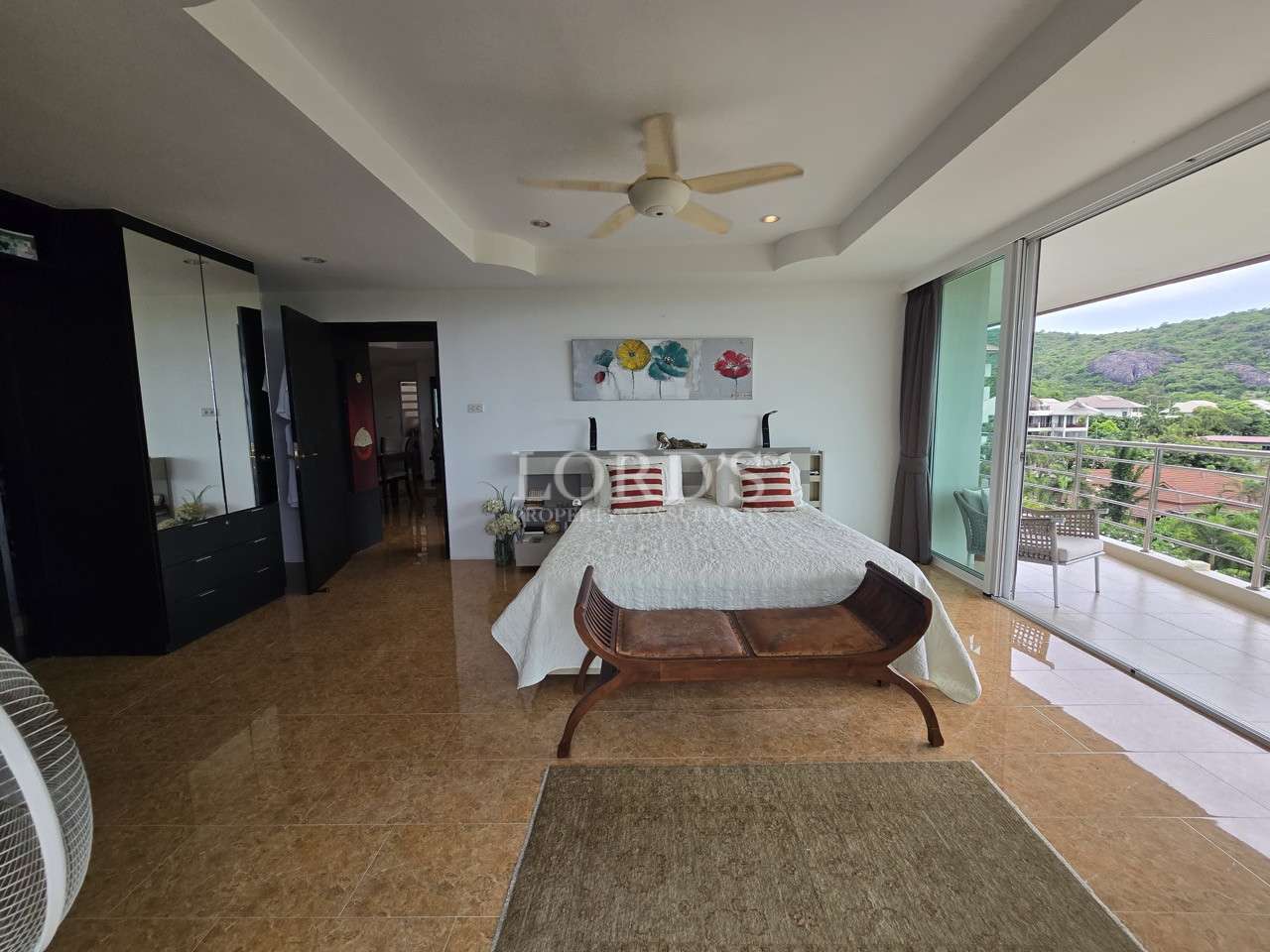 Bright bedroom with balcony access and mountain views.