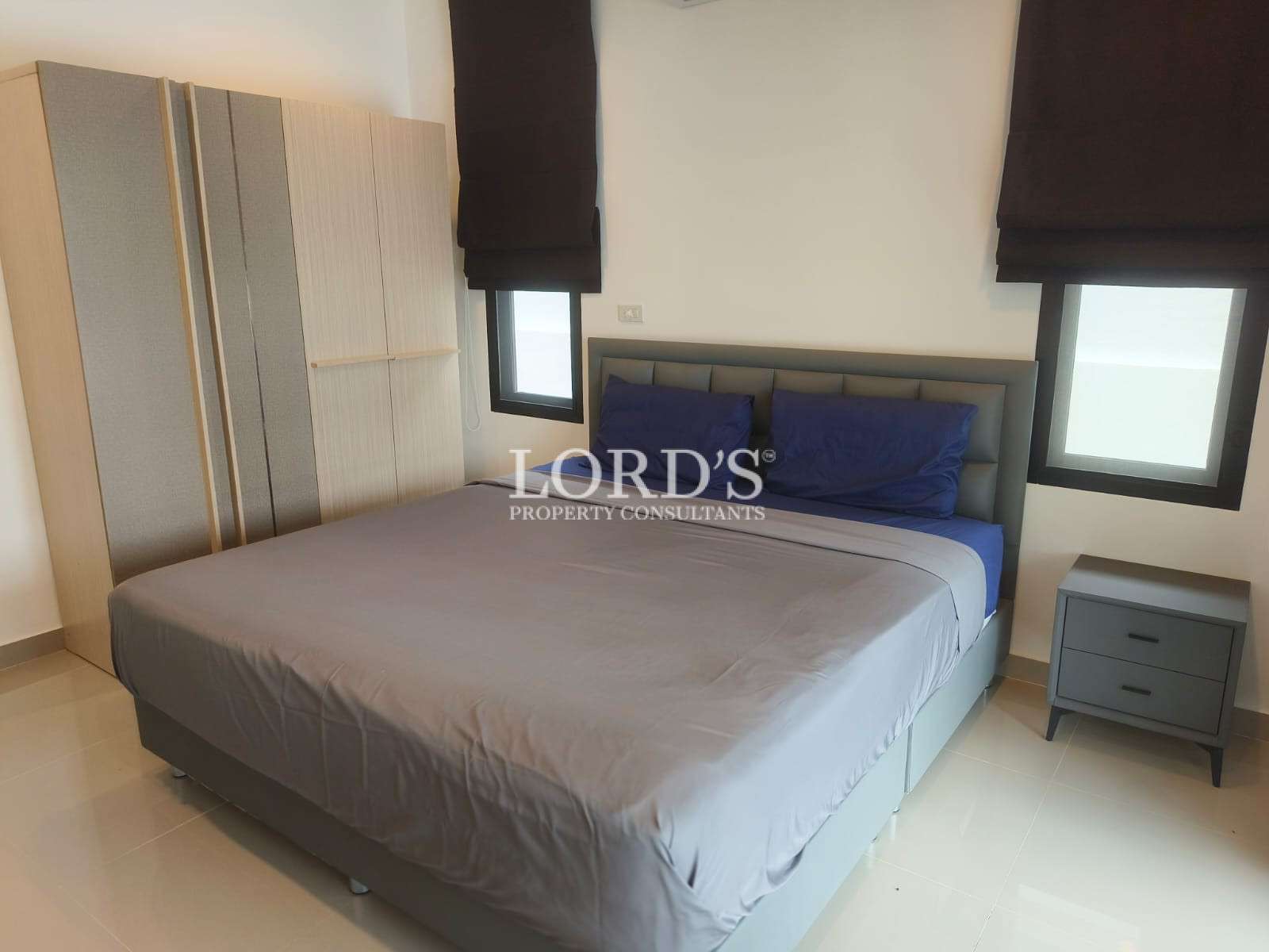 Contemporary bedroom with built-in wardrobe and minimalist design.