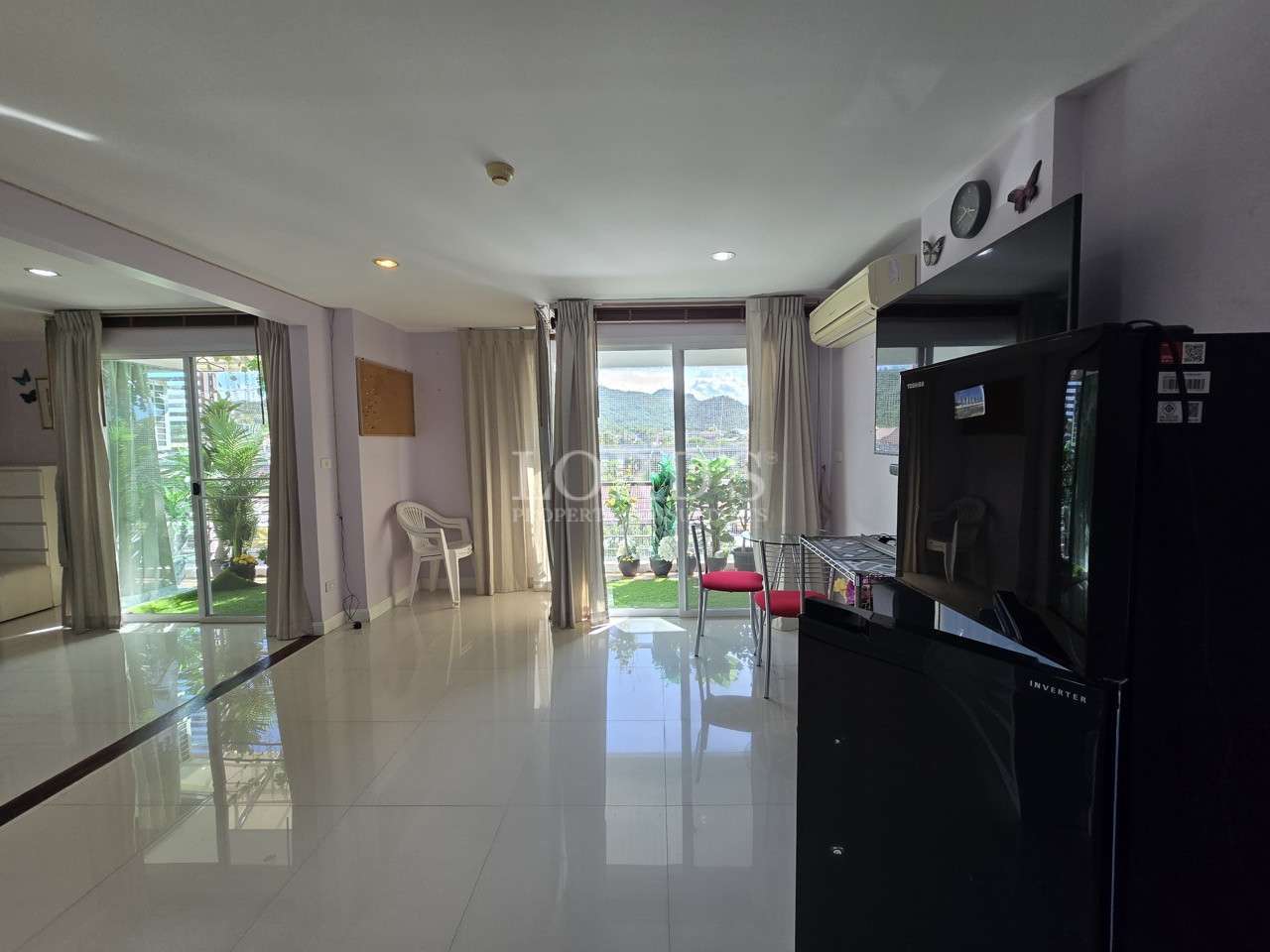 Bright living area with sliding glass doors and balcony view.