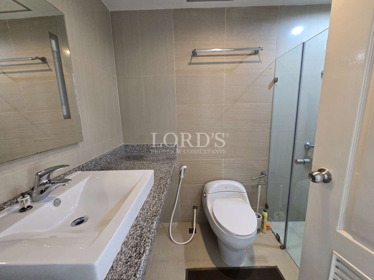 Modern bathroom with walk-in shower and vanity sink.