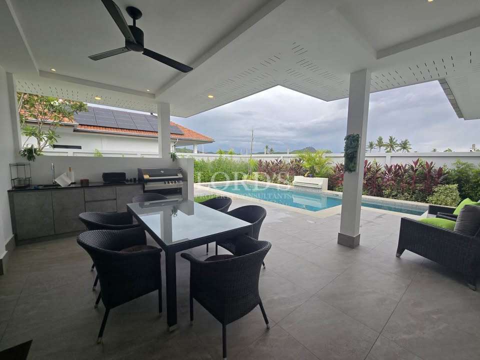 Modern outdoor dining area with pool