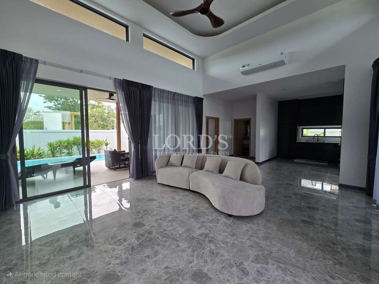 Spacious modern living room with curved sofa, marble floor, and sliding doors to pool.