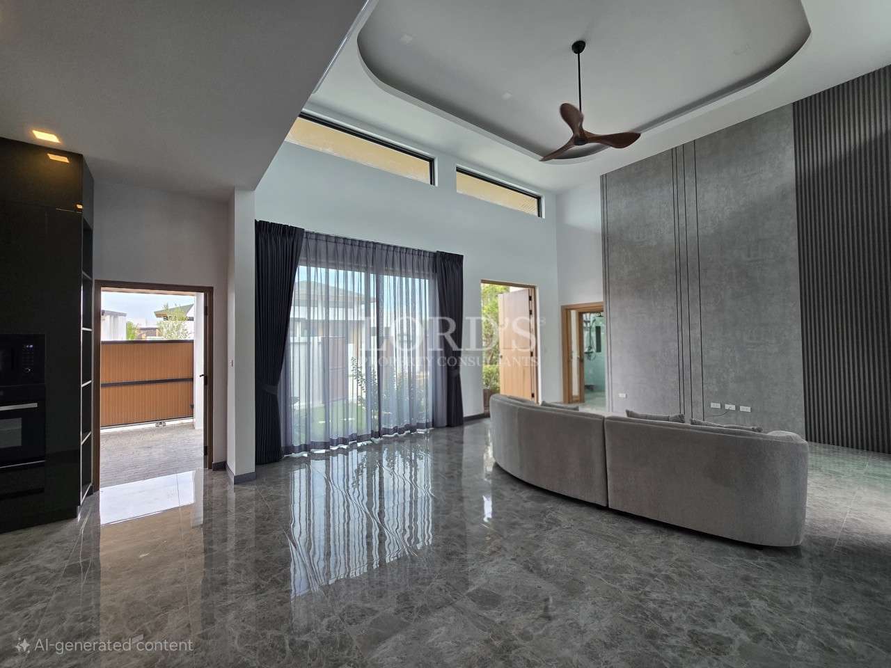 Modern living room with high ceiling, marble floor, curved sofa, and large glass doors.