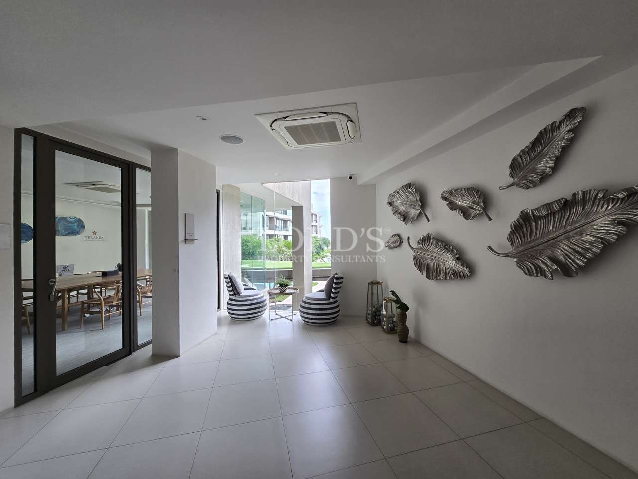 Modern condominium lobby with seating area and decorative wall art
