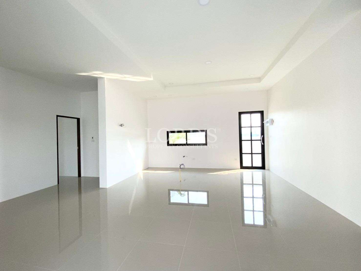 Spacious open-plan living and dining area with glossy tiled floor and modern ceiling.