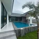 Modern private pool villa with covered terrace and landscaped garden
