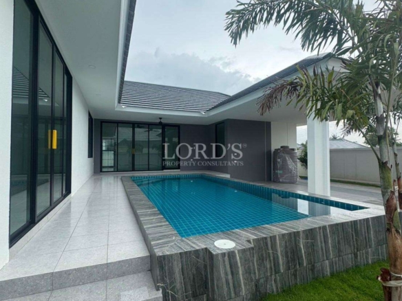 Modern private pool villa with covered terrace and landscaped garden