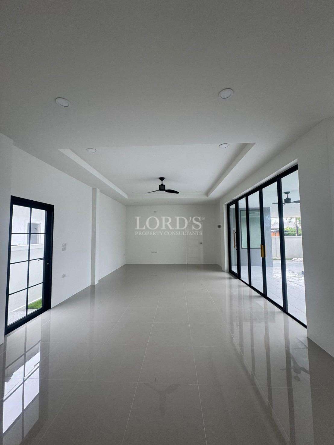 Spacious modern living room with tiled floor and sliding glass doors