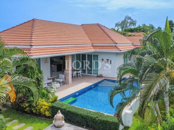 Tropical villa exterior with private pool and tiled roof
