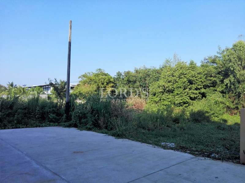 Concrete road beside land plot