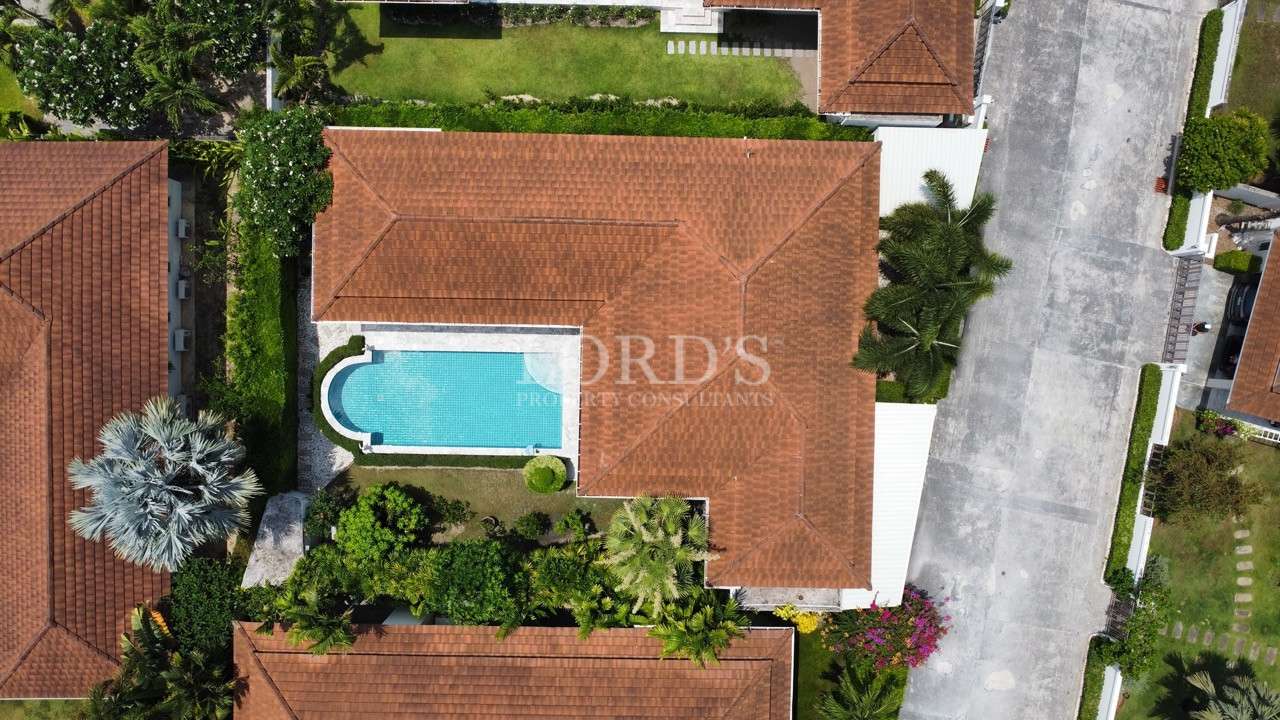 Top-down aerial view of a villa with private swimming pool and landscaped garden