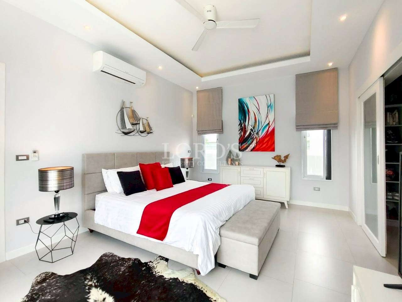 Modern bedroom with red accents.