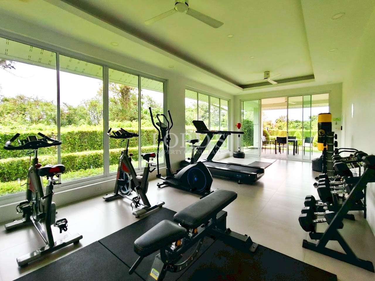 Modern gym with exercise equipment.