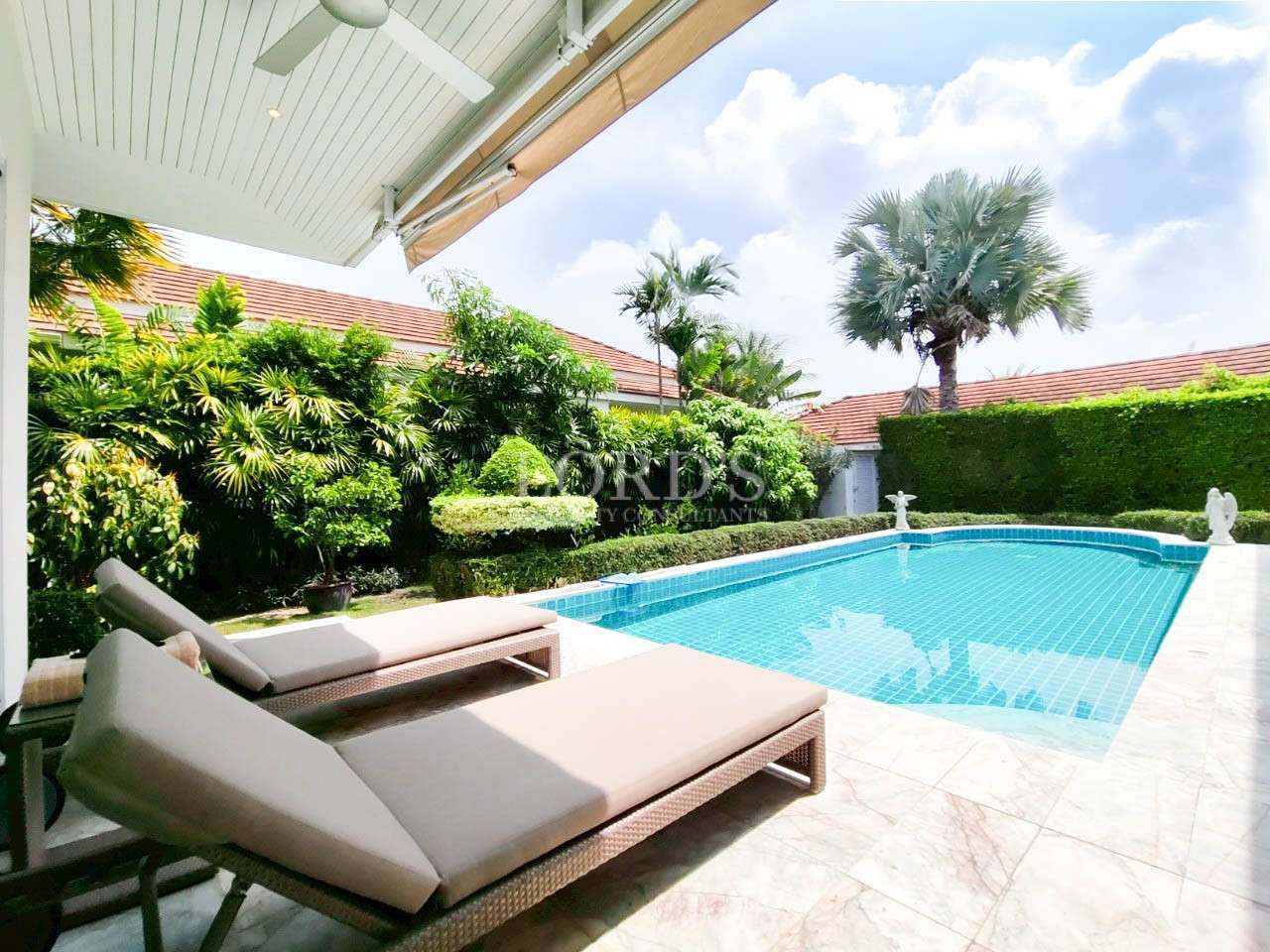 Luxurious poolside with tropical landscaping