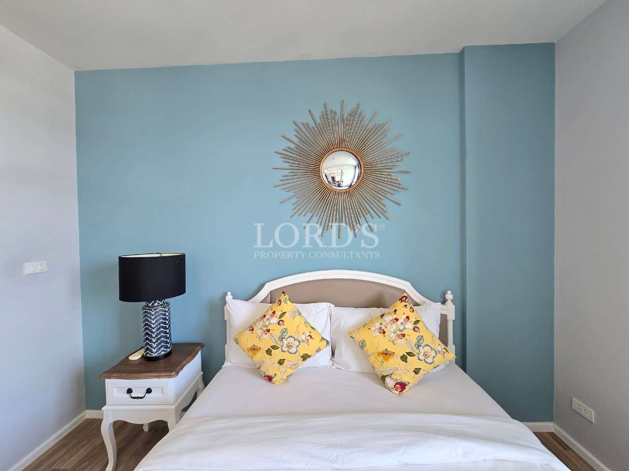 Cozy bedroom with decorative pillows.