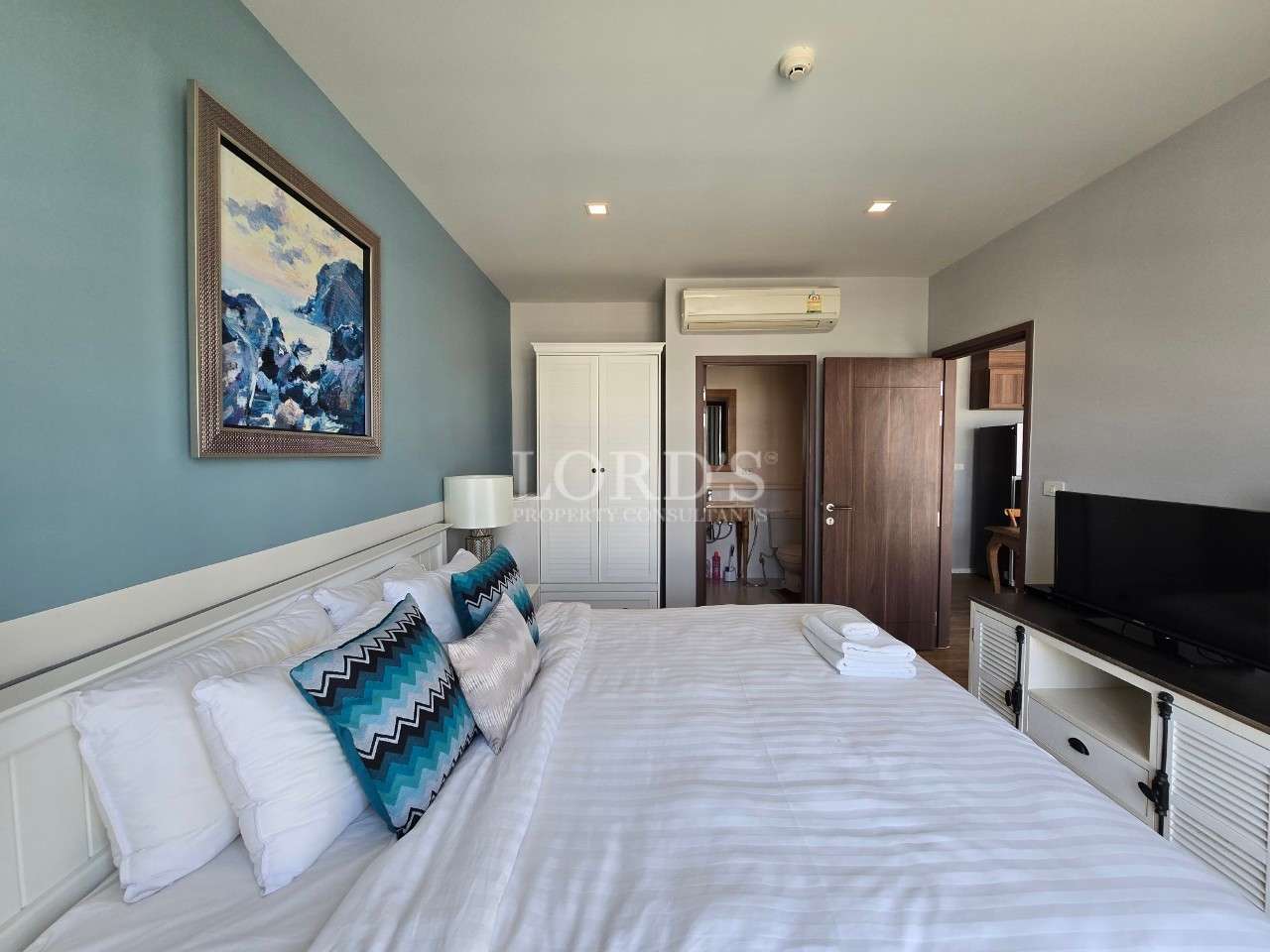 Modern bedroom with blue accents.