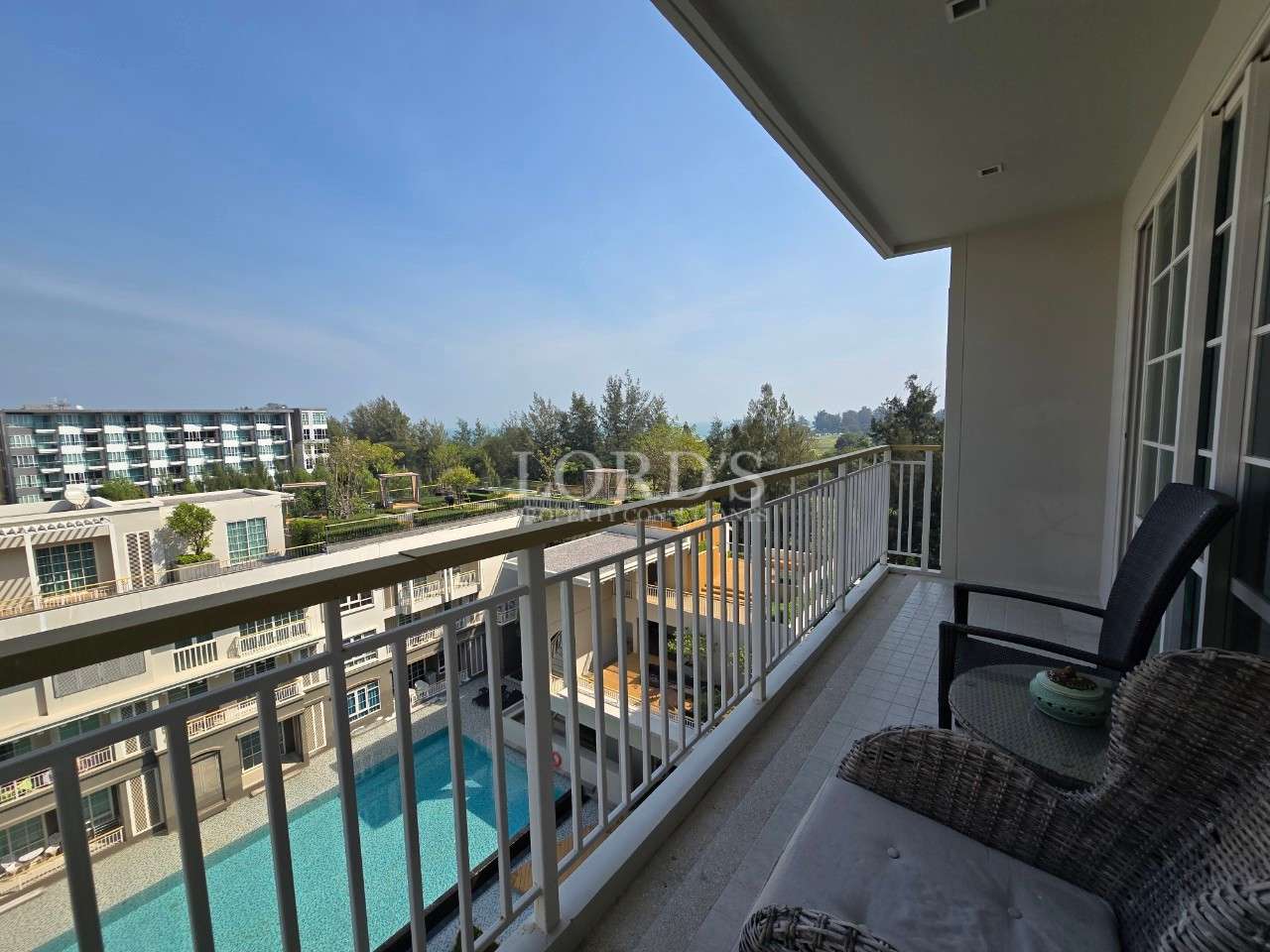 Balcony view overlooking a pool.