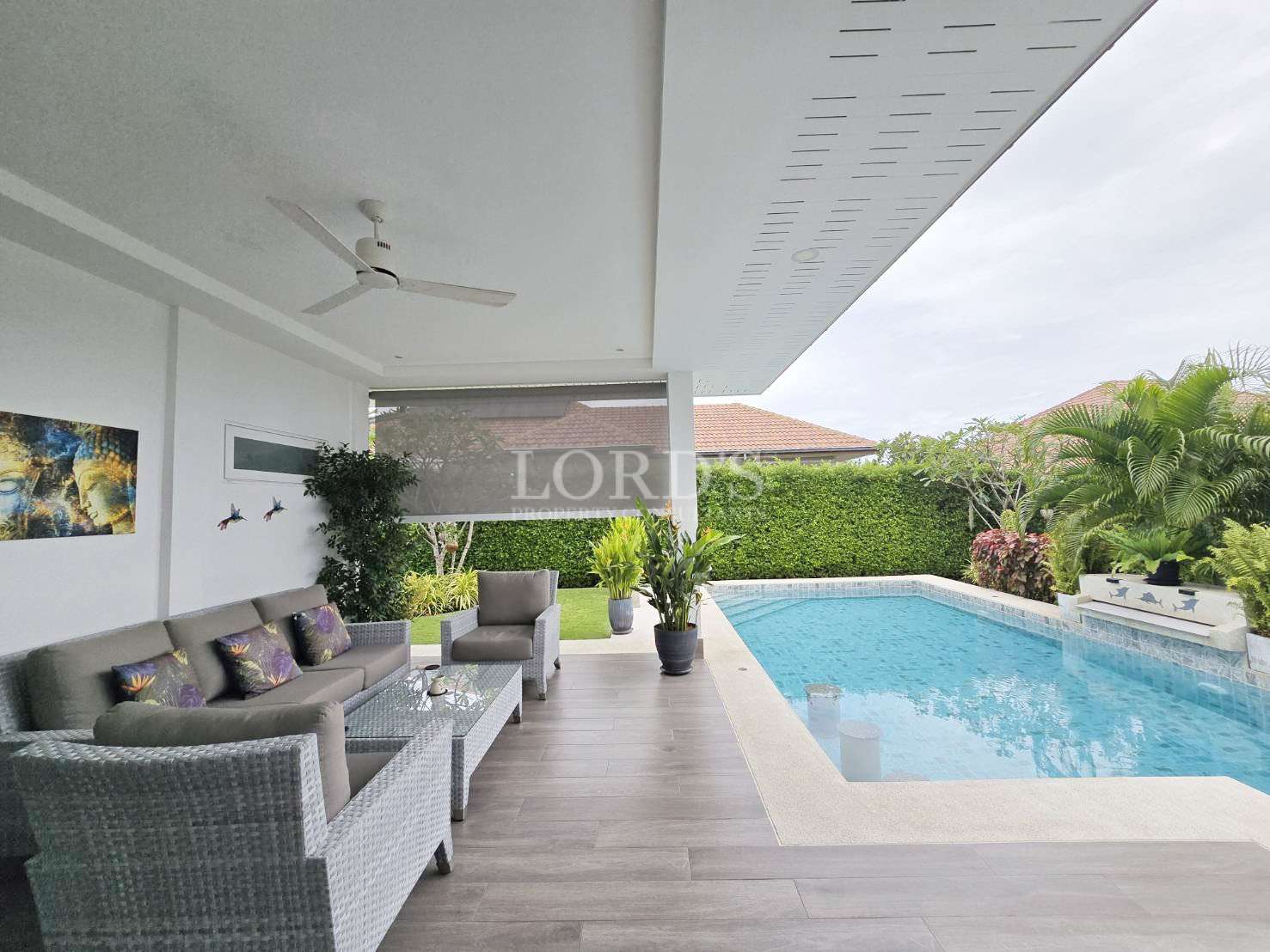 Modern patio with pool and greenery