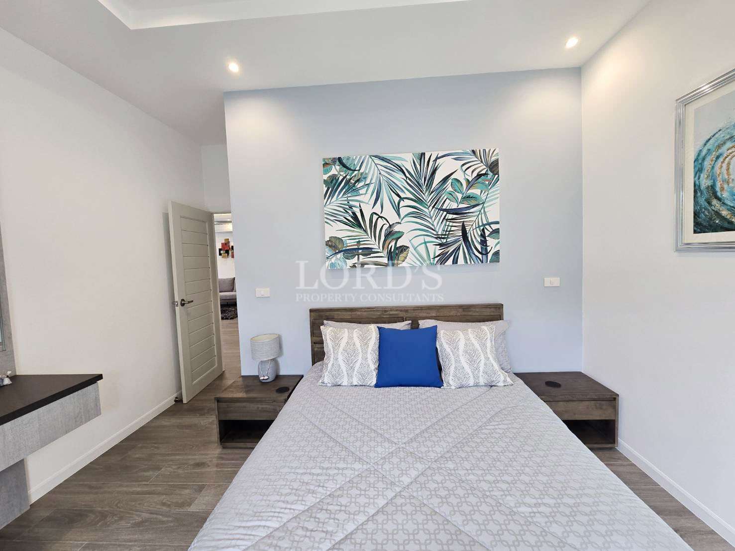 Modern bedroom with tropical artwork.