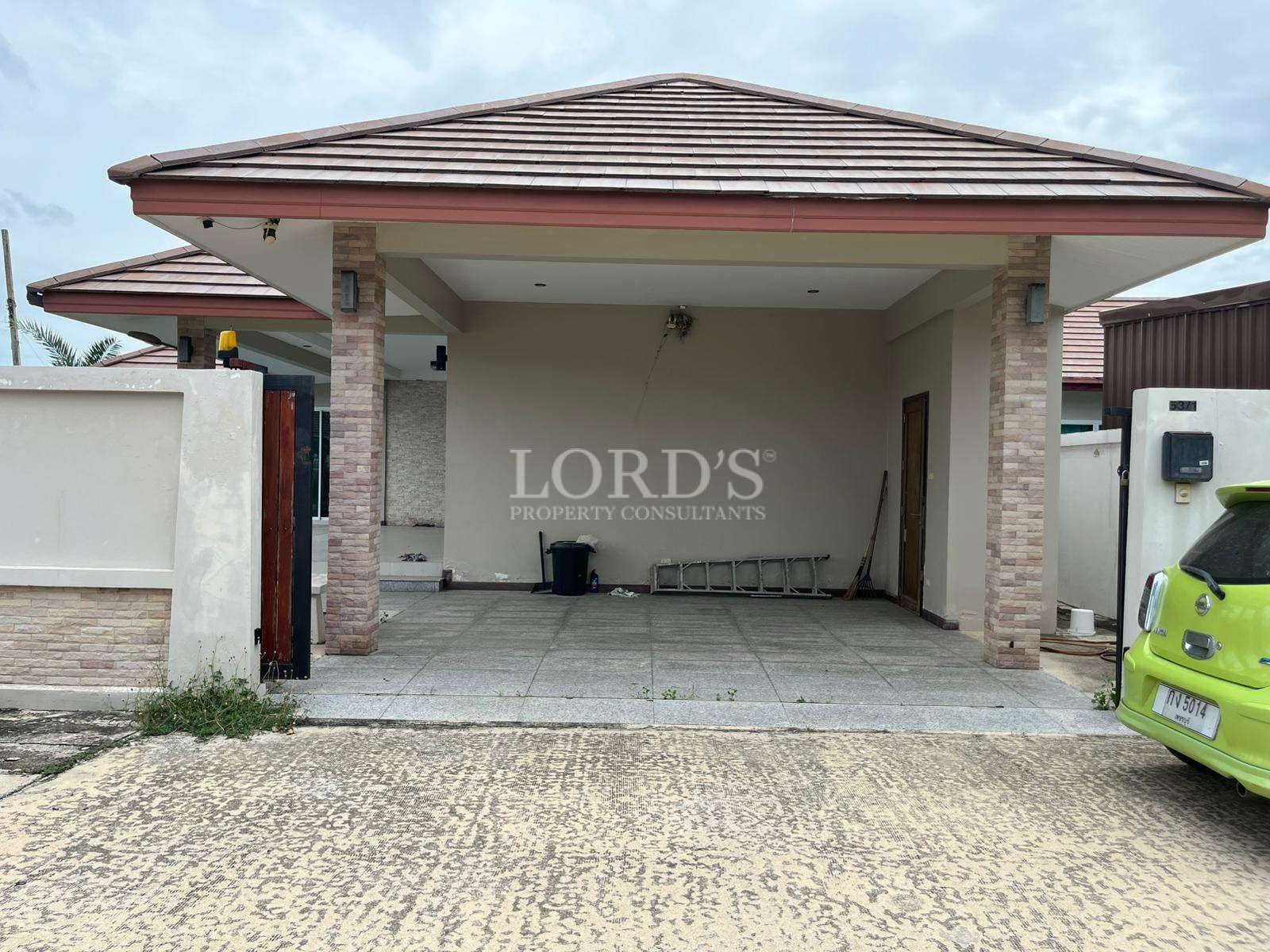 Covered carport with tiled floor and modern roof design