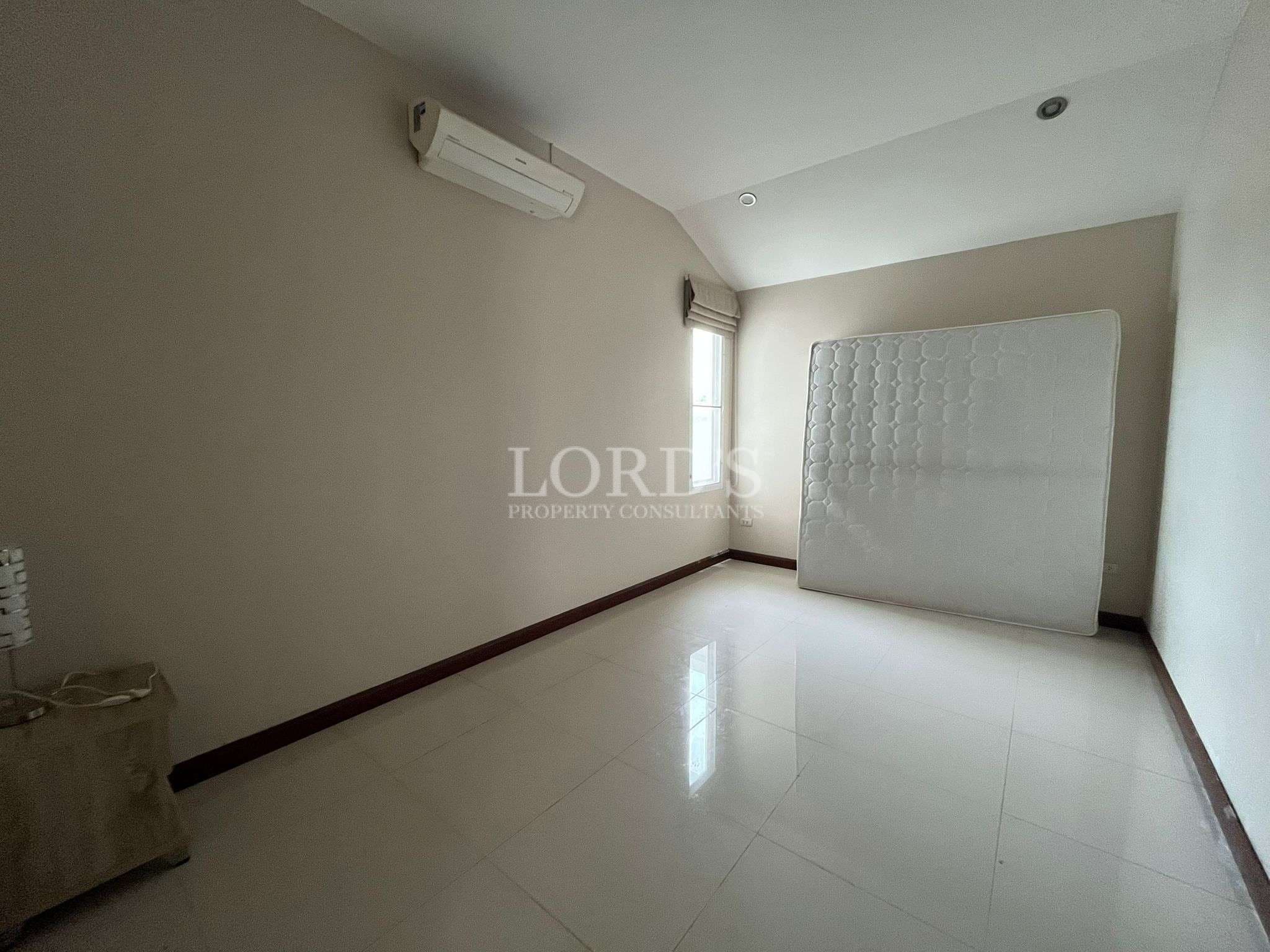 Empty room with mattress against wall