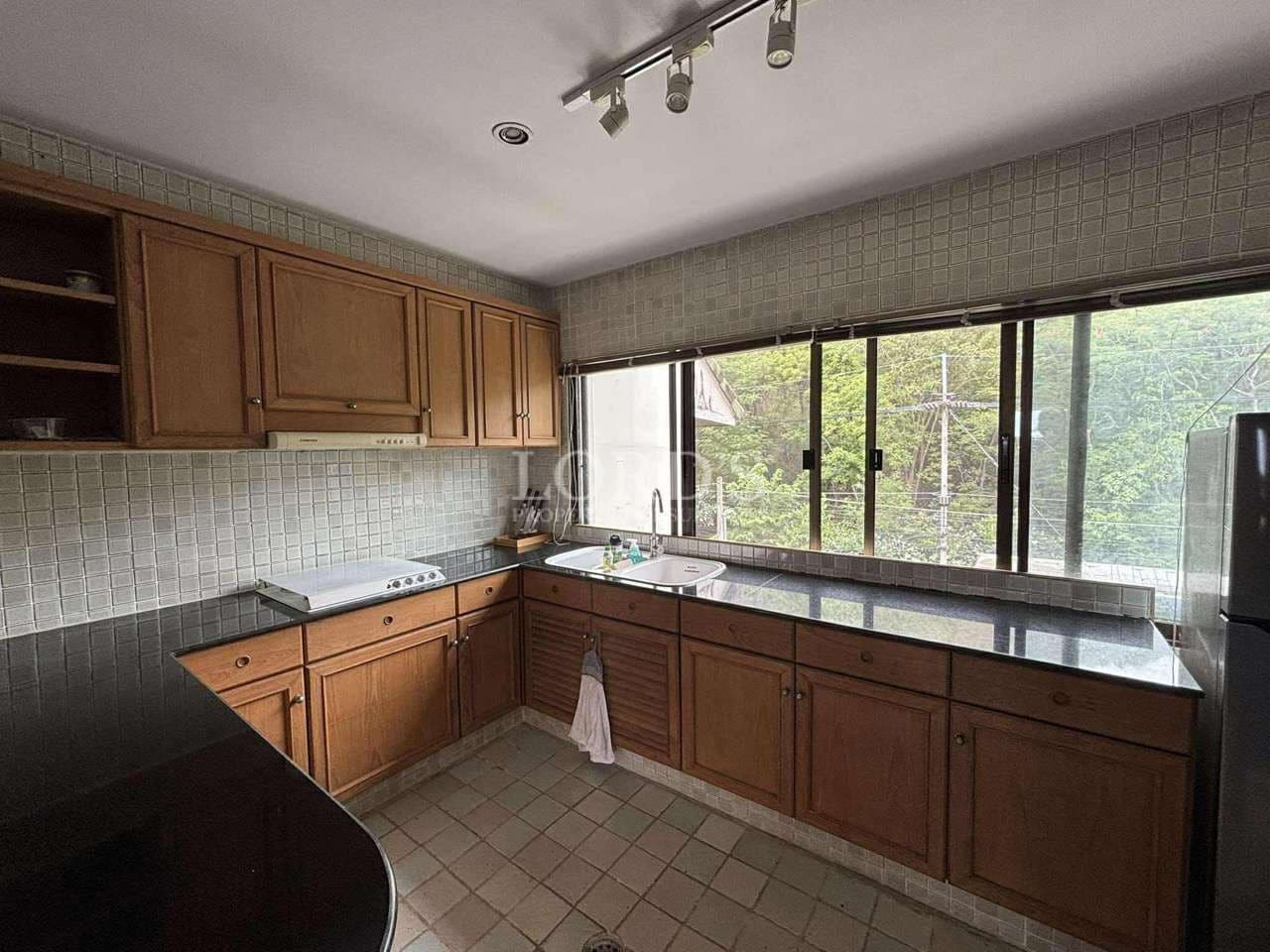 Spacious kitchen with wooden cabinets.
