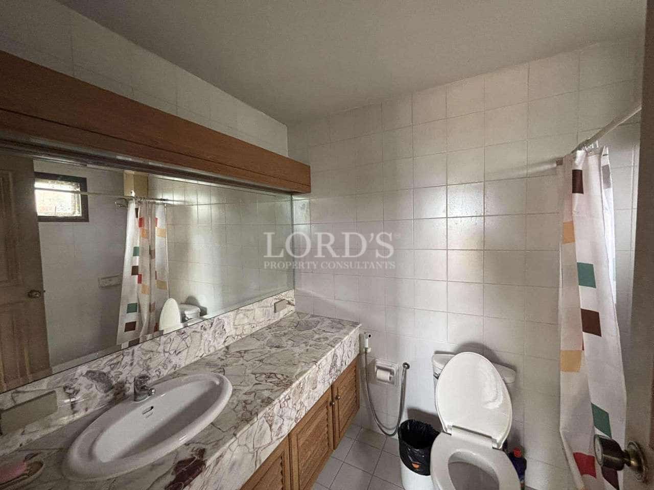 Bathroom with marble countertop and mirror