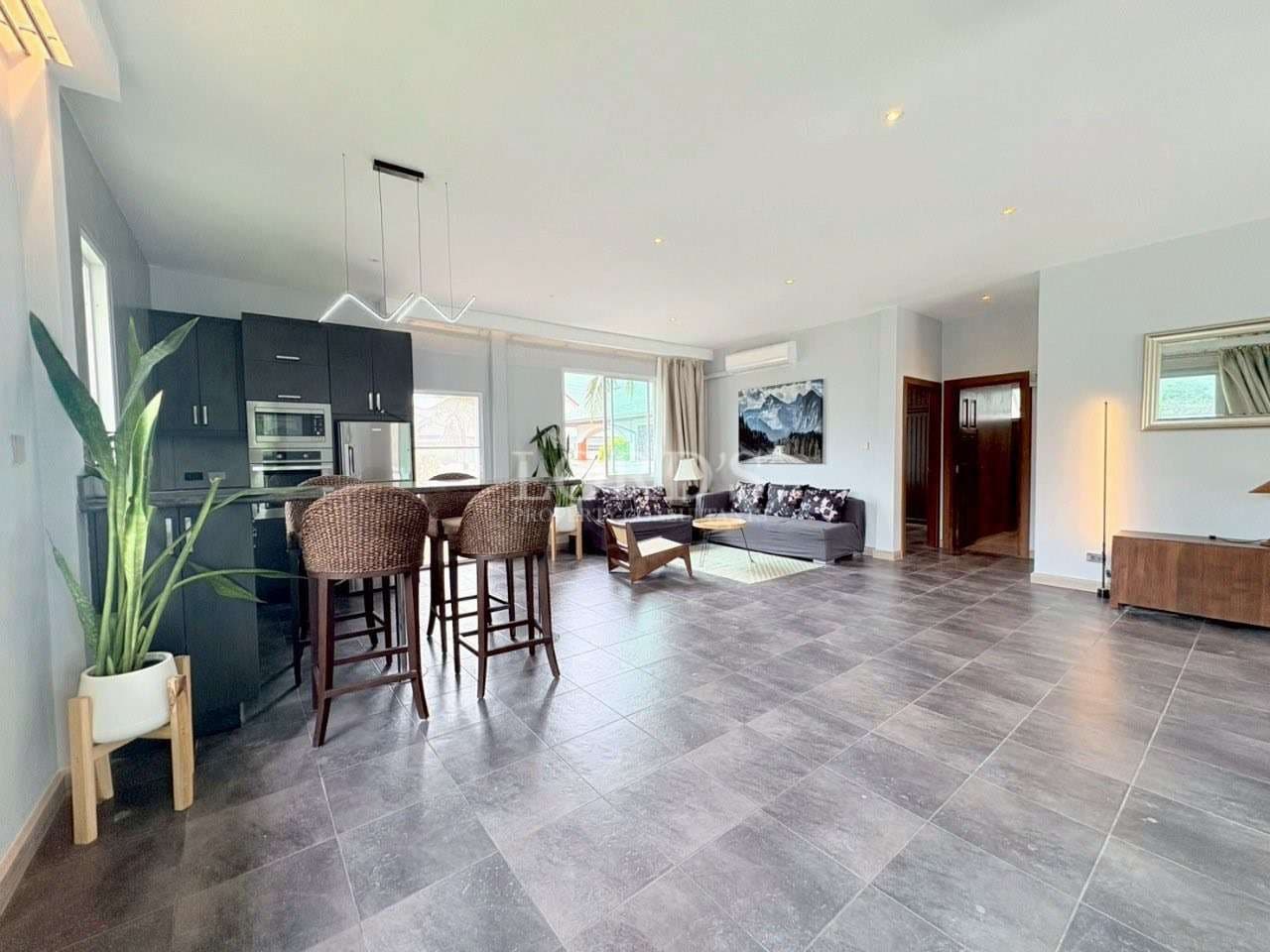 Spacious open-plan living room with modern kitchen and seating area