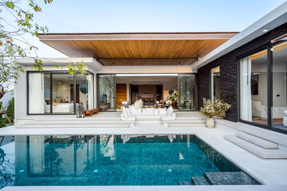 Luxury modern pool villa with private swimming pool, wooden roof ceiling, and open living spaces.