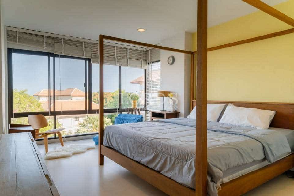 Modern bedroom with large windows