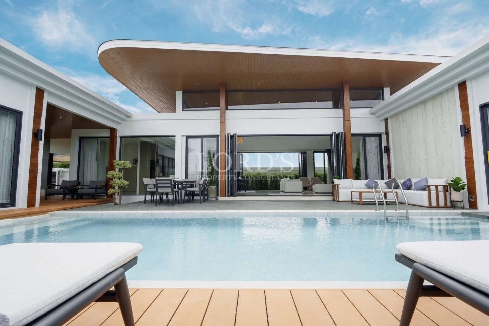 Modern luxury villa with private swimming pool, open-plan outdoor seating, and contemporary architecture.