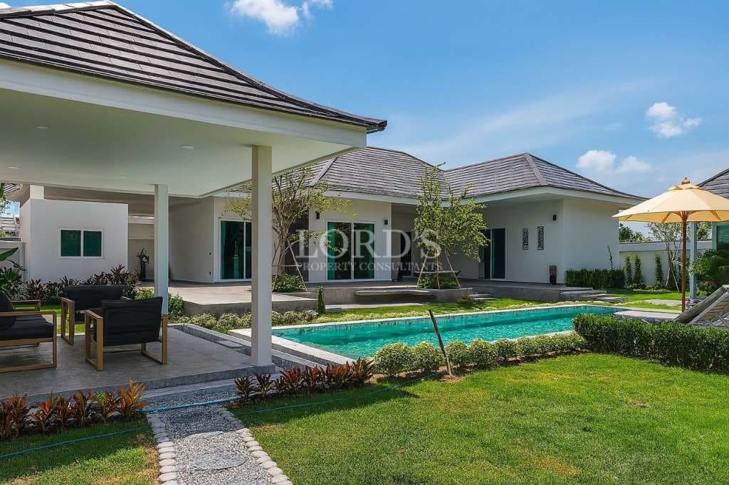 Modern luxury villa with private swimming pool, covered patio, and landscaped garden
