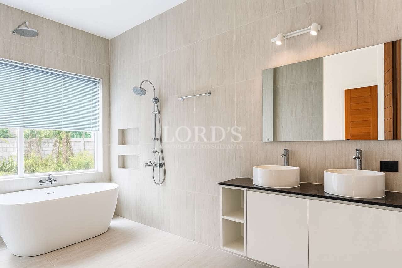 Modern bathroom with freestanding bathtub, walk-in shower, and double vanity sink