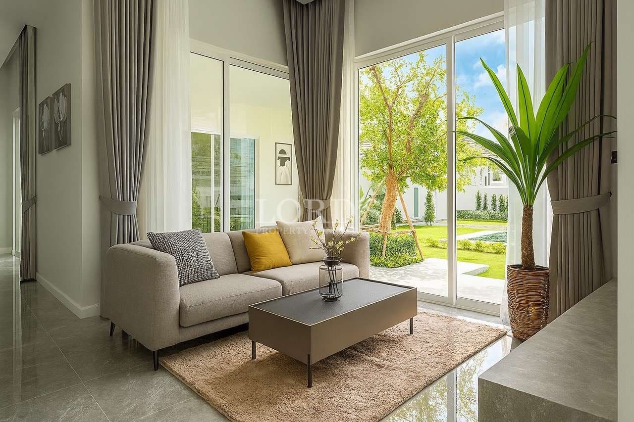 Bright modern living room with large windows, garden view, and minimalist furniture