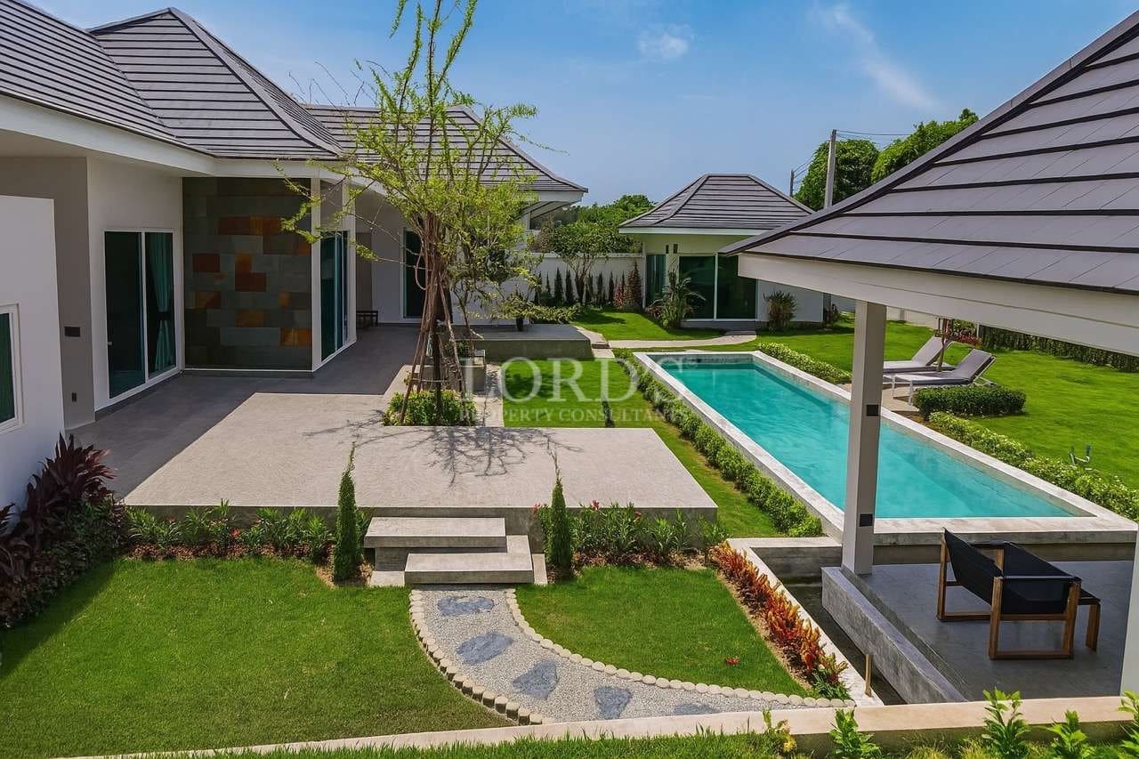 Modern luxury villa with private swimming pool, landscaped garden, and outdoor patio