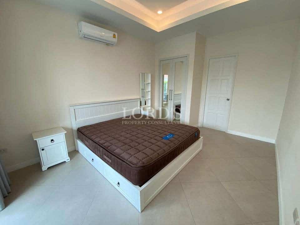 Empty bedroom with a bed.
