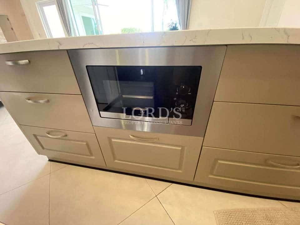 Modern kitchen with built-in microwave.