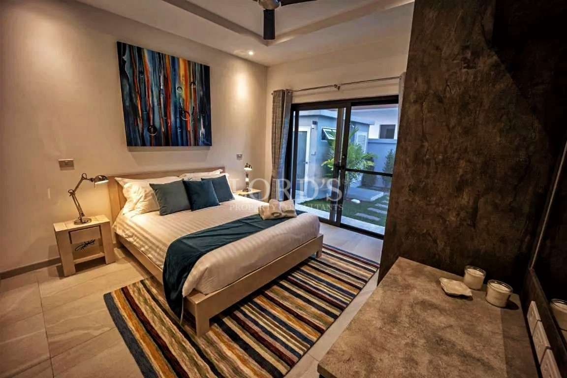 Modern bedroom with colorful artwork.