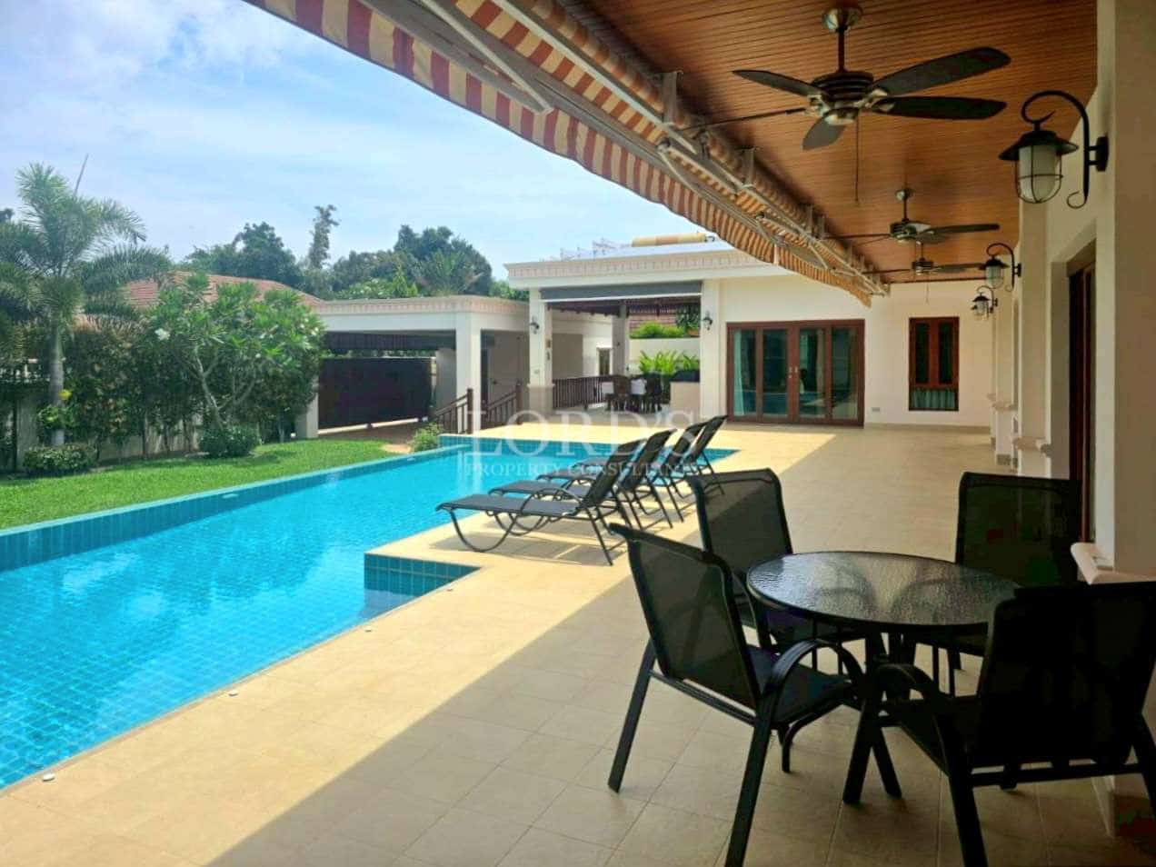 Covered poolside terrace with private swimming pool and sun loungers
