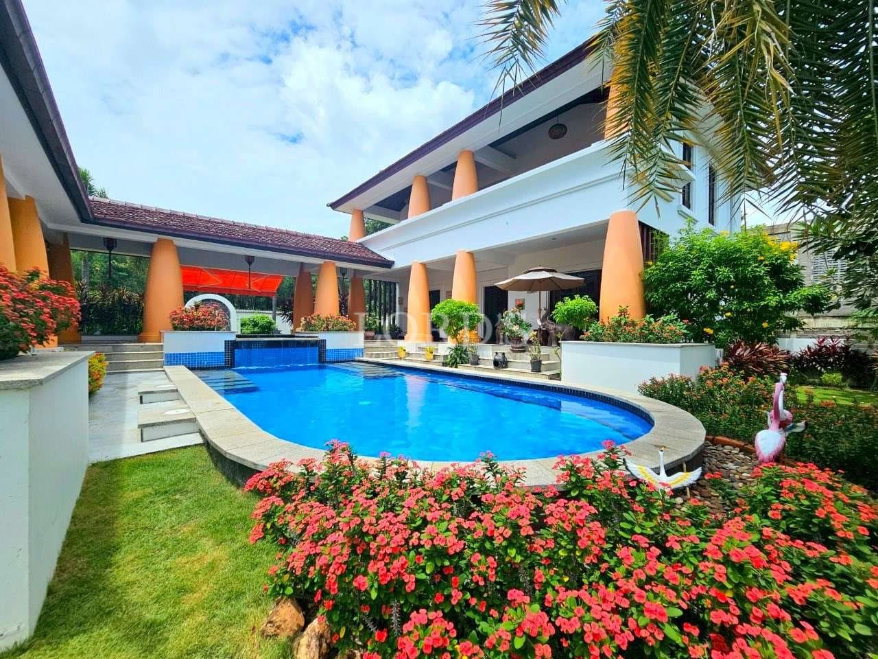 Luxury villa with a private swimming pool, landscaped garden, and modern tropical architecture