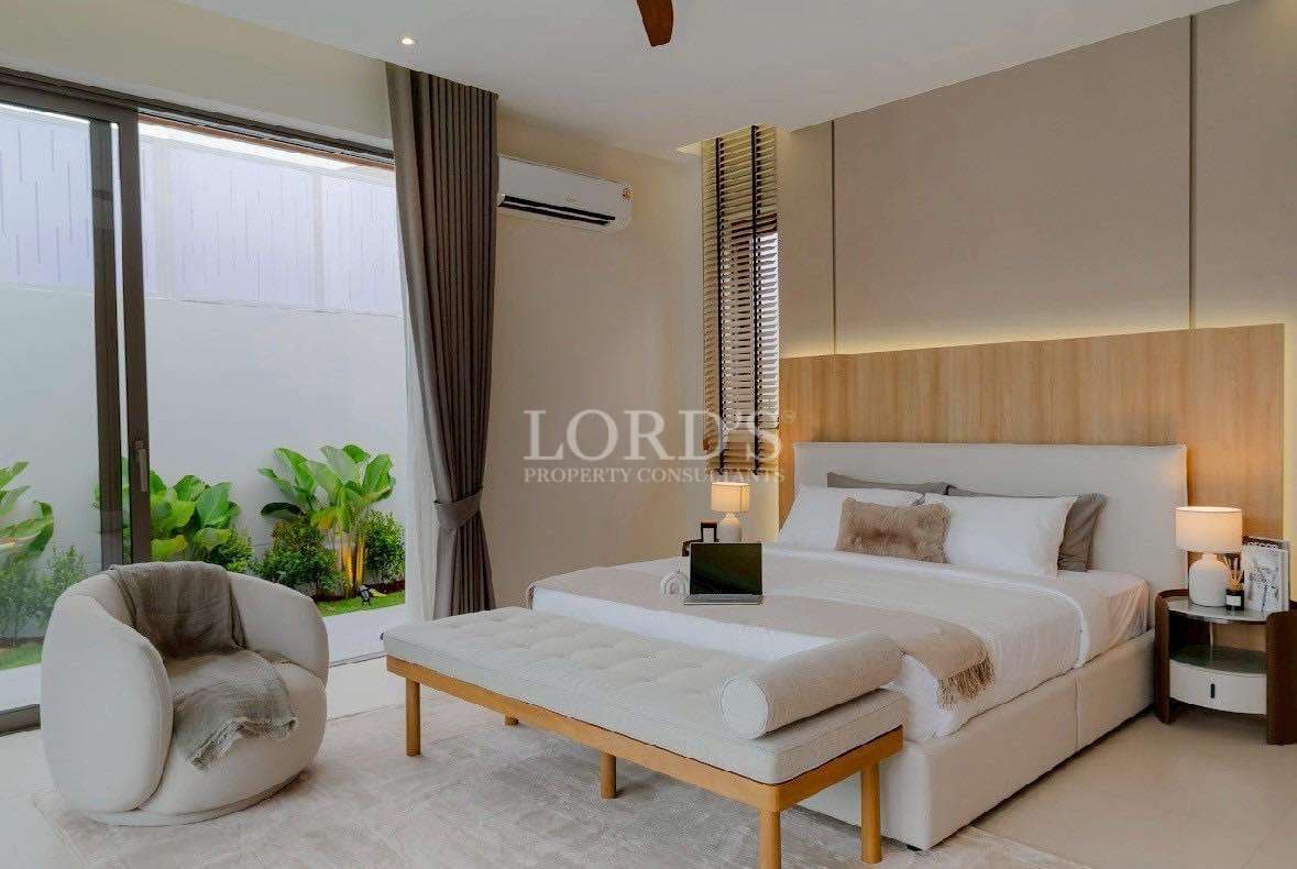 Luxury modern bedroom with upholstered bed, warm wooden paneling, and soft ambient lighting.