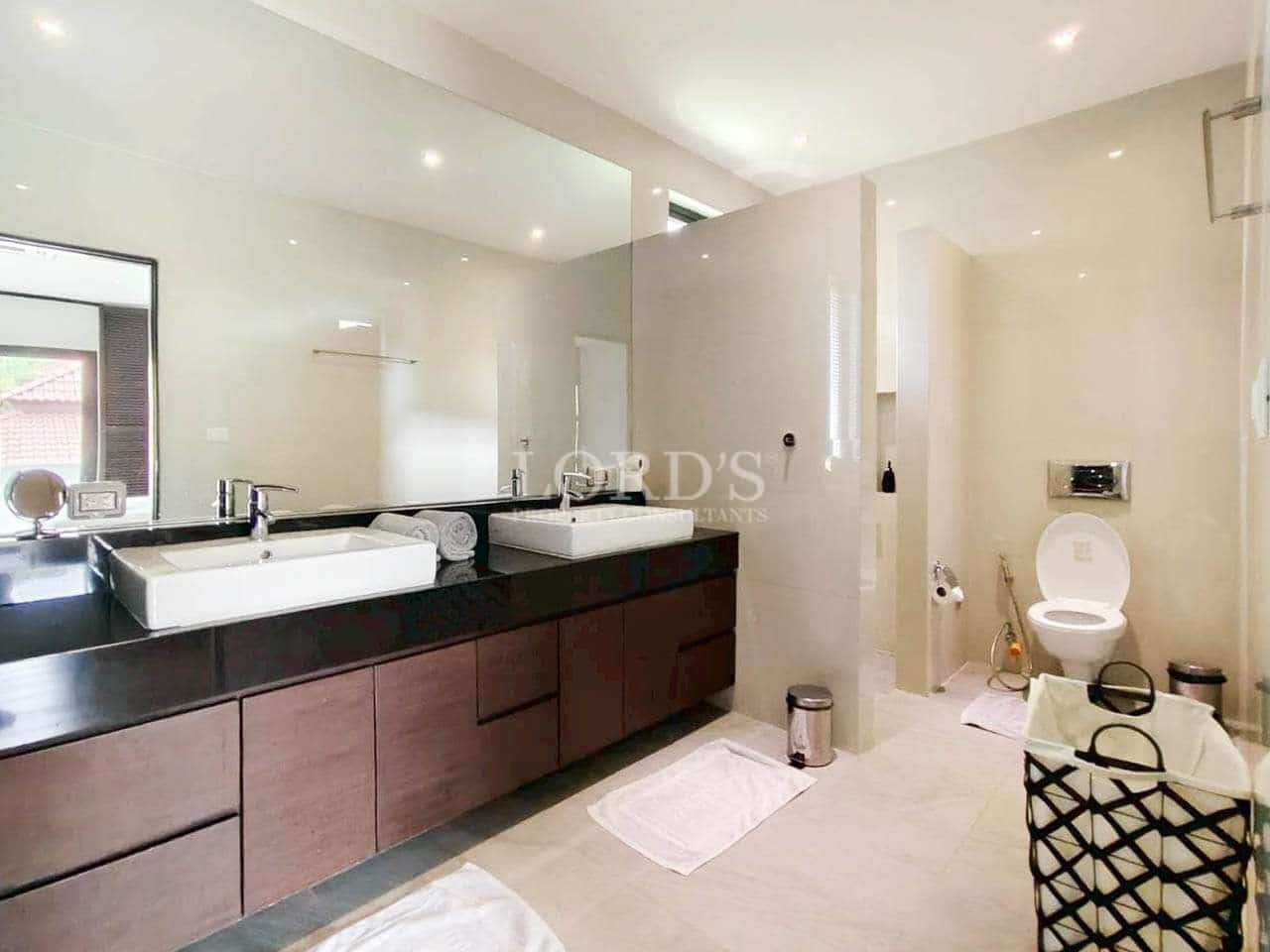 Modern bathroom with dual sinks.