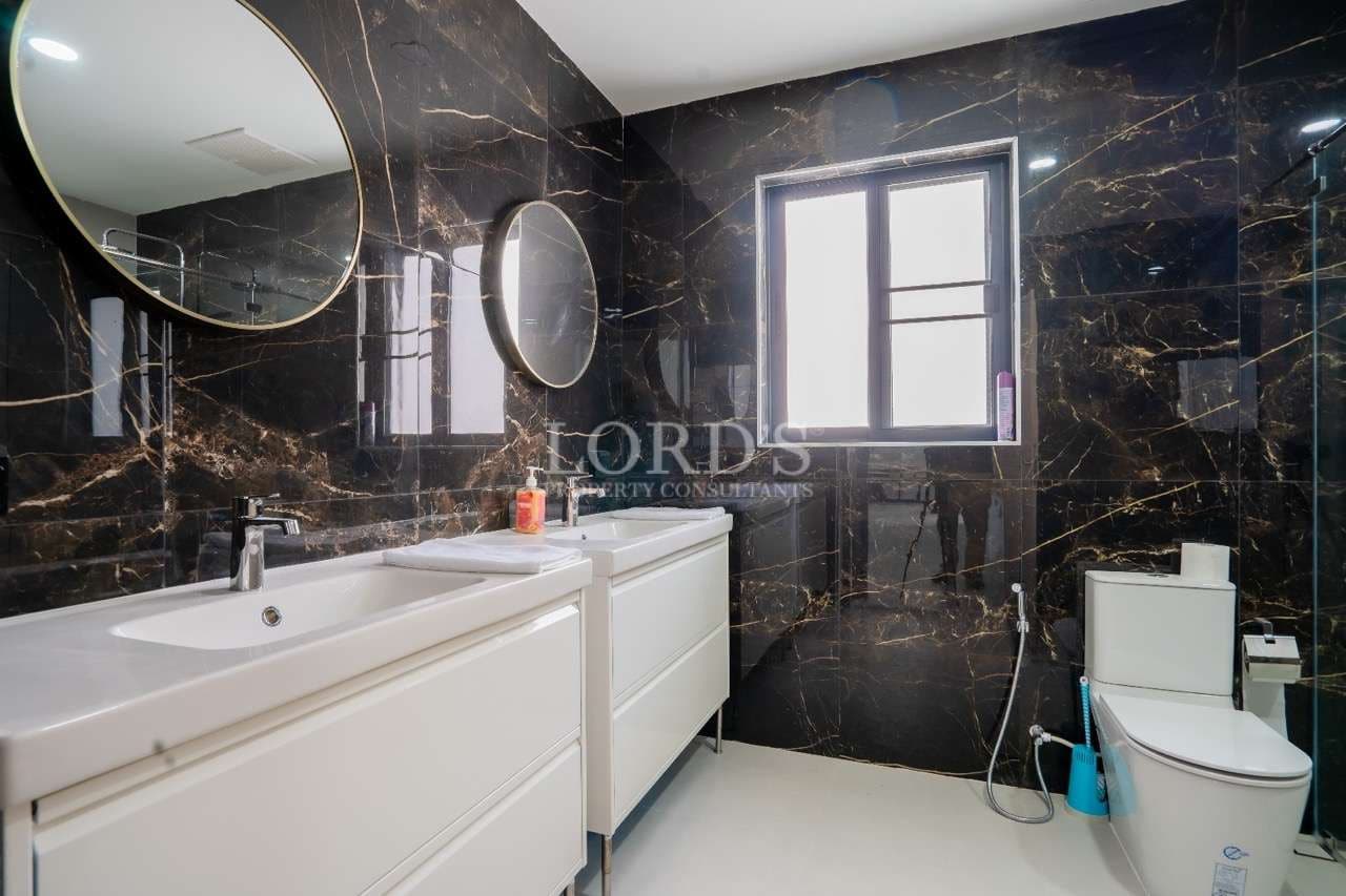 Modern bathroom with dark marble walls