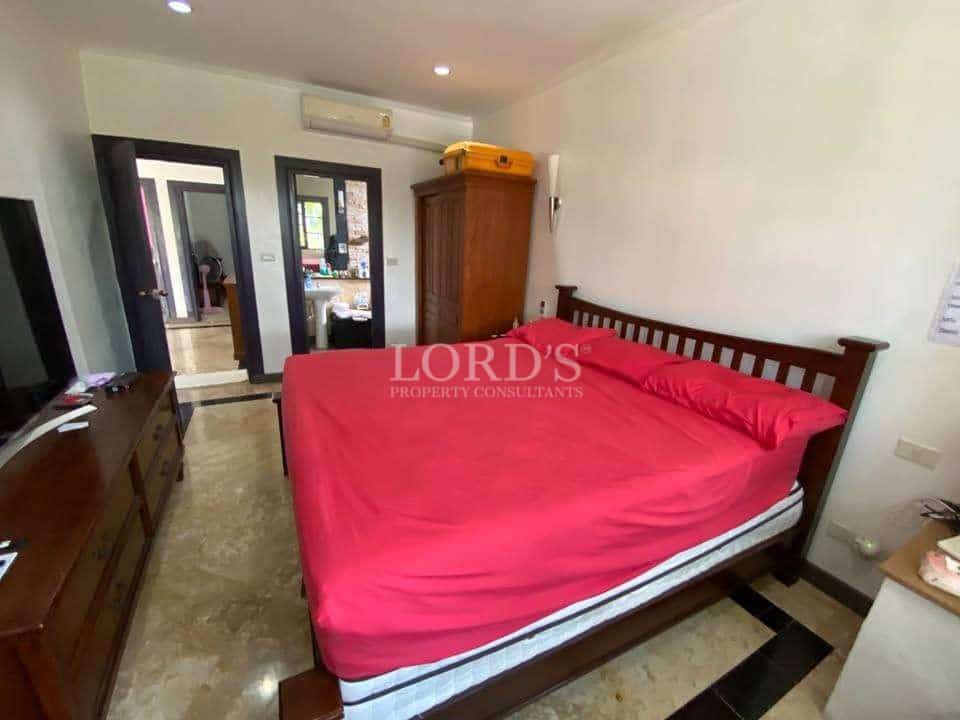 Cozy bedroom with red bedding.