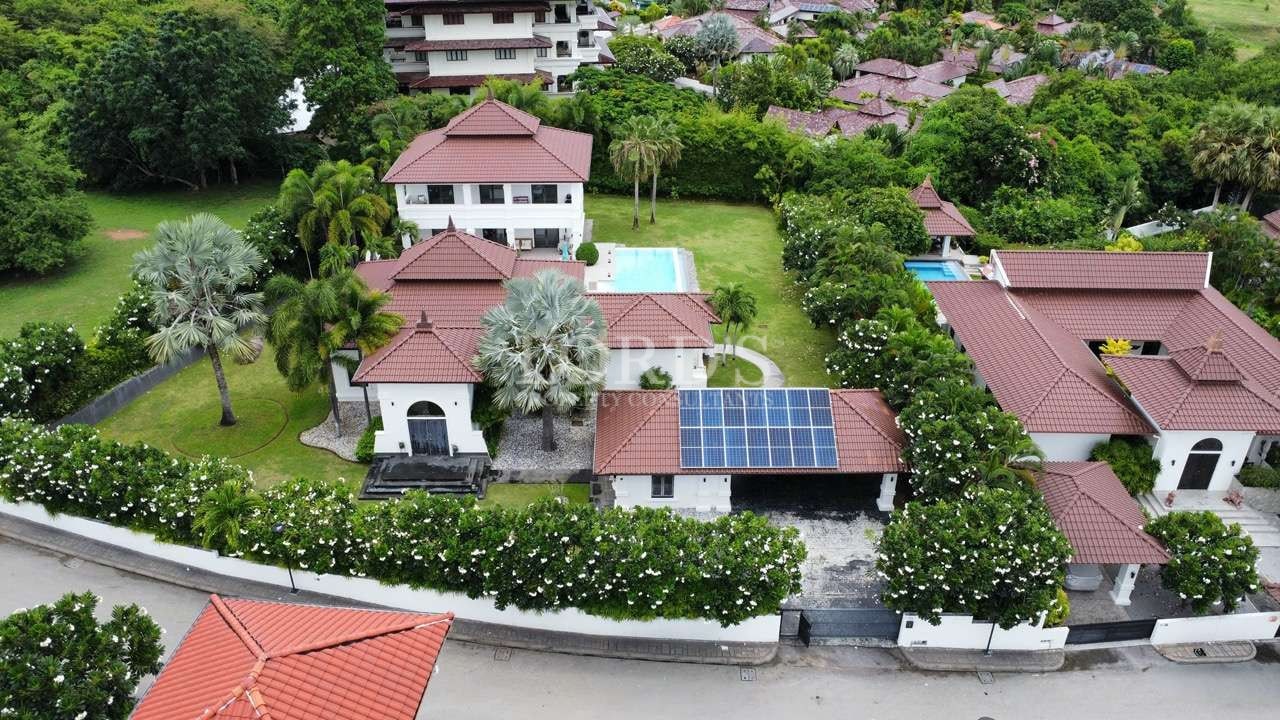Aerial view of tropical villas and greenery.