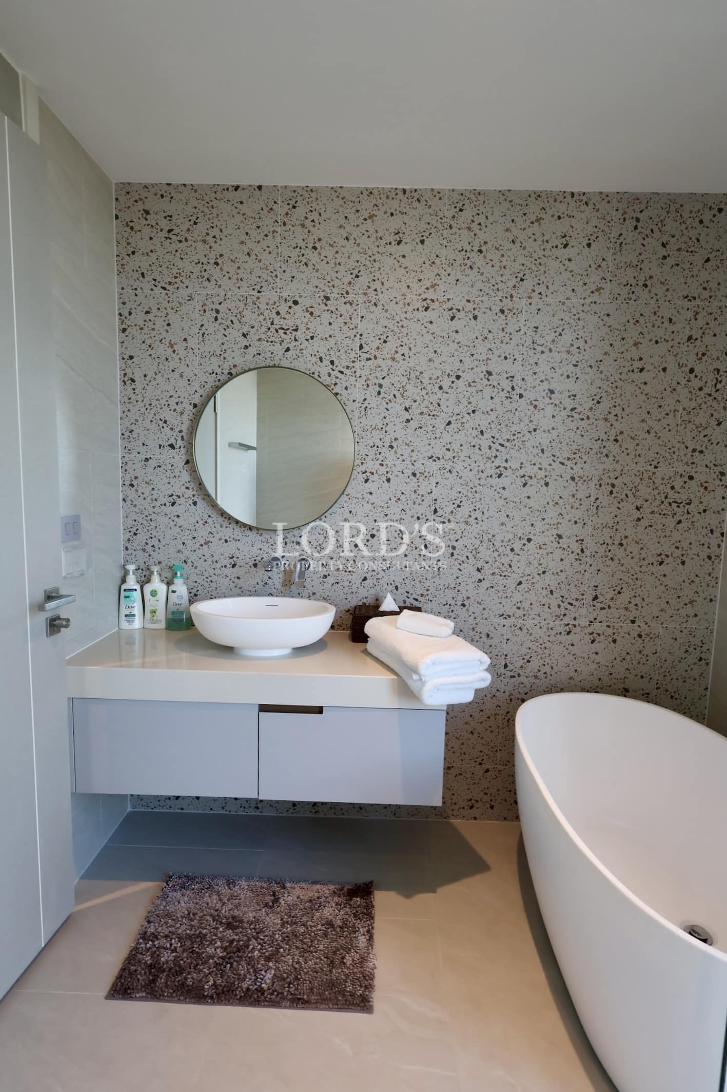 Bathroom sink with round mirror and decor