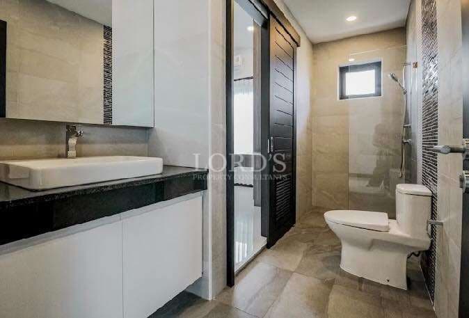 Modern bathroom with walk-in shower, vanity sink, and contemporary fixtures.