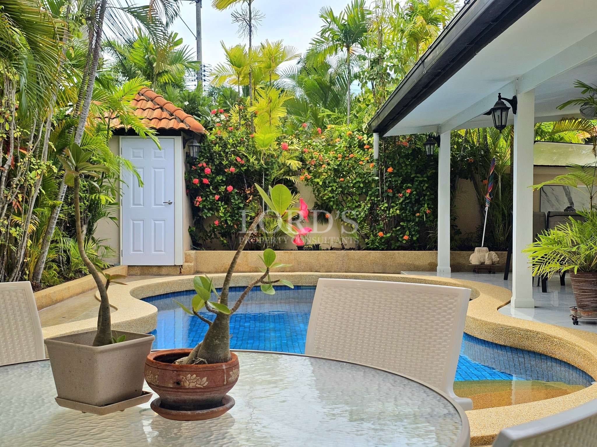 Tropical poolside with lush greenery