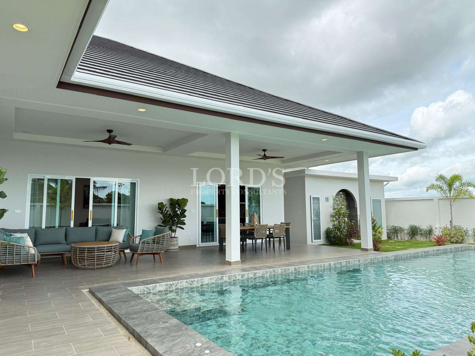 553191117_762292813294481_8272159732239701734_n Luxury villa poolside patio with covered seating area, outdoor dining space, and private swimming pool.